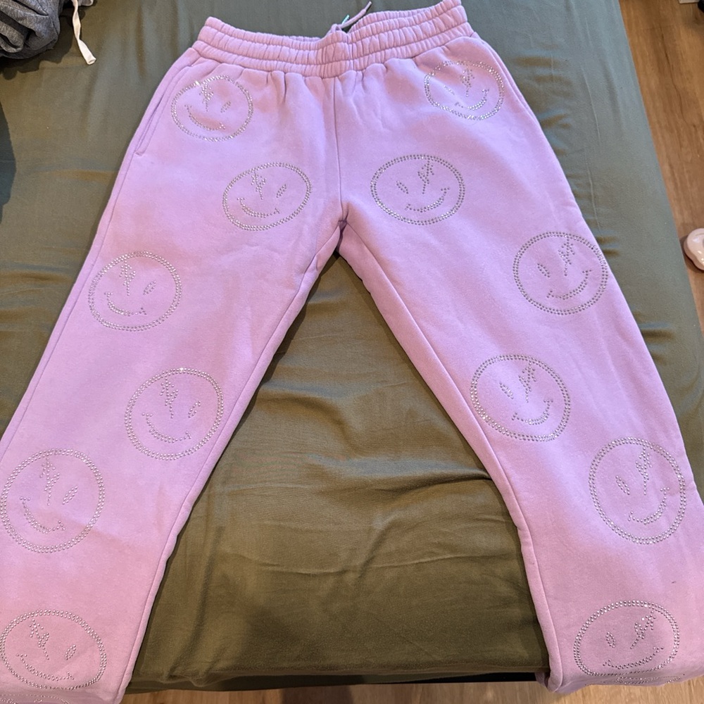 Purple joggers with diamond smiley faces